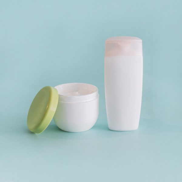 cream-jar-near-plastic-bottle